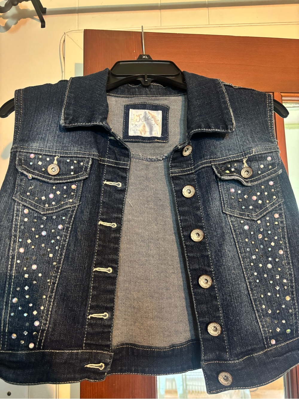 Justice dark blue denim vest with white label